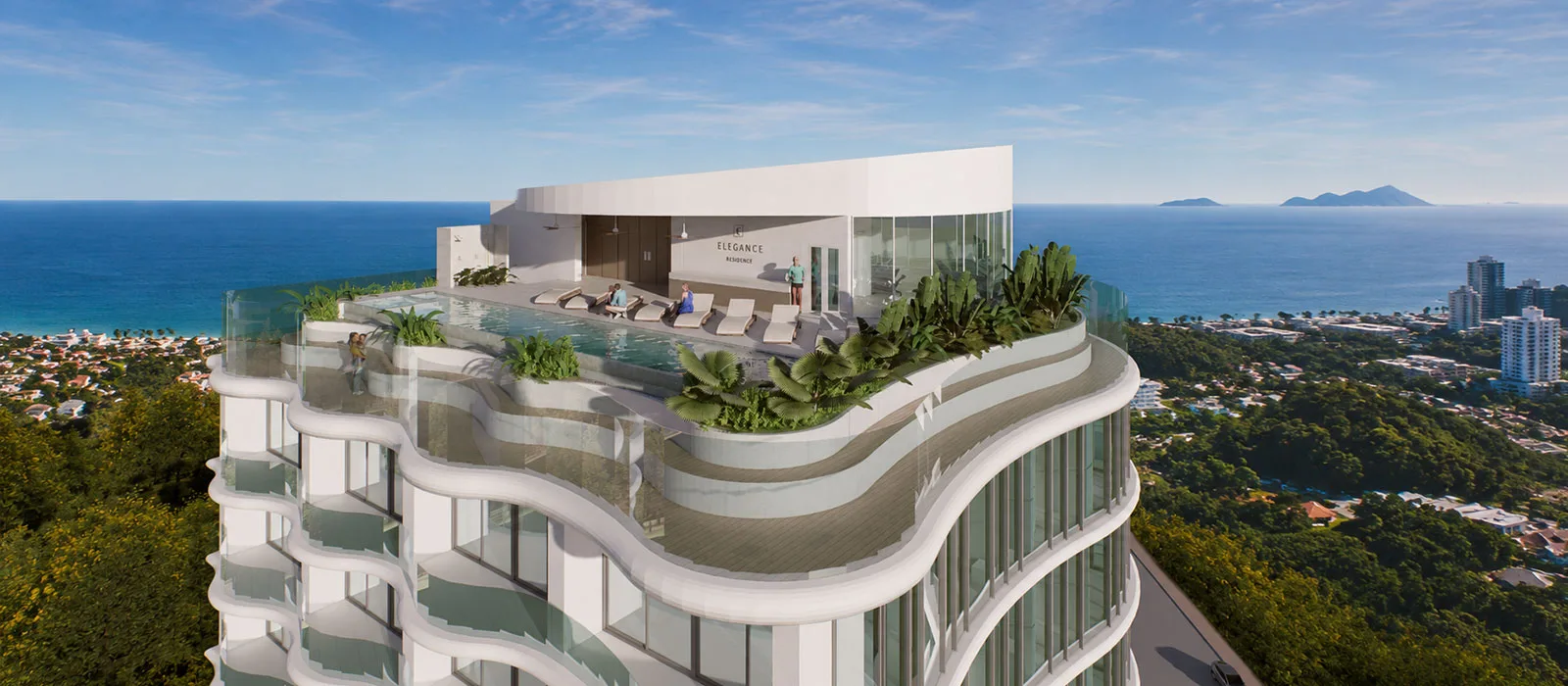 The upper floors and rooftop terrace seen from above, with the coastline behind