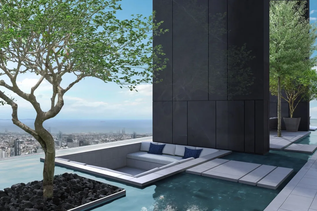 Rooftop sky pool framed by a frangipani tree over the bay