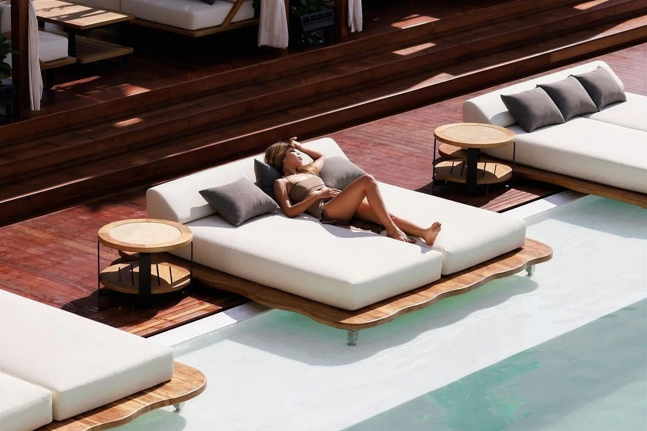 Beachfront pool with floating day beds and cabanas